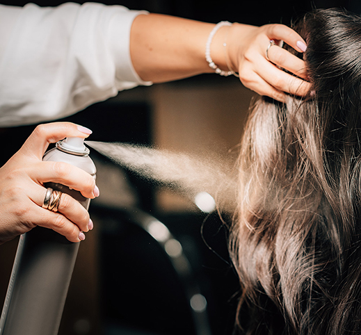 A stylist finishing a fresh style at Salon Bastille in Cincinnati